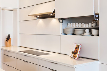 New modern white kitchen with open recipe book