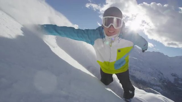 SLOW MOTION: Cheerful snowboarder carving