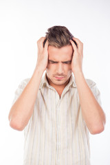 Naklejka premium Handsome young man touching his head feeling headache