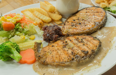 Grilled salmon steaks in white plate