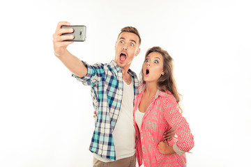 Funny couple in love making selfie photo with smartphone