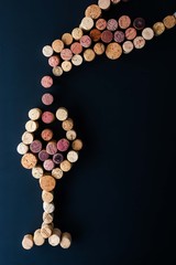 Filling a glass of wine from the bottle made by cork vertical
