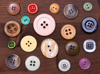 Colored buttons seen from above on wooden table