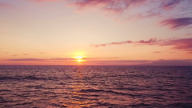 Aerial Flight Over Ocean Into Dramatic and Vibrant Hawaiian Sunset in Slow Motion
