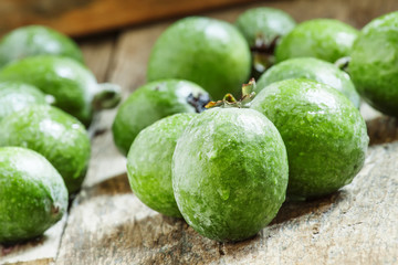 Fresh green feijoa on the old wooden background, selective focus