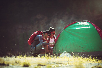 Young couple setting up tent outdoors,hiking and camping.Setting tent.