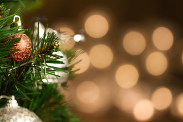 beautiful Christmas ball on the defocused background of yellow lights. Festive decoration.