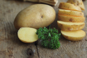 fresh potatoes on wood background