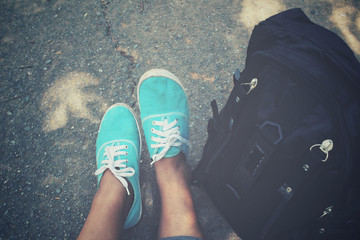 Fototapeta premium Woman tourist with a backpack and sneakers