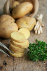 fresh potatoes on wood background