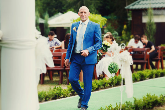 Joyful Happy Bride In Blue Suit Is On The Green Track At Wedding