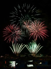 Fototapeta premium Golden orange amazing fireworks isolated in dark background close up with the place for text, Malta fireworks festival, 4 of July, Independence day, New Year, explode