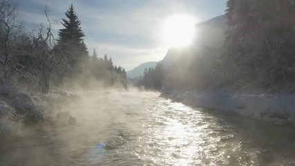 AERIAL: Misty river in winter morning