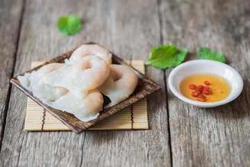 Fish dumplings in wooden dish on old wood background.