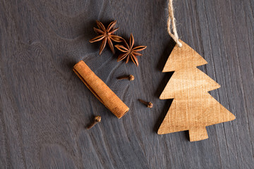 Wooden christmas tree on wooden background and anise