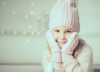 Portrait of pretty little girl in hat and gloves