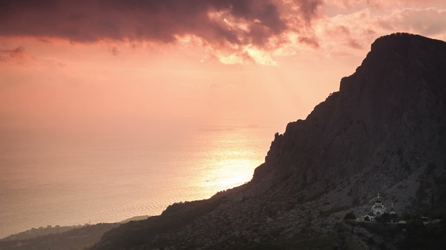 Church on the rock under the clouds at sunset. Timelapse. Russia, Crimea.