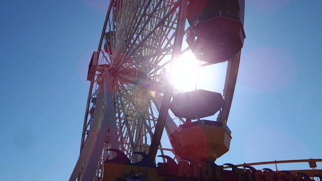 Ferris wheel spinning over the sun