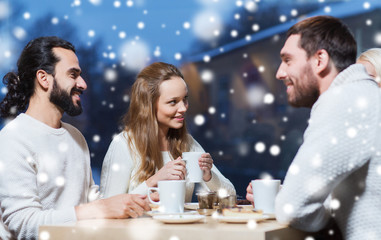 happy friends meeting and drinking tea or coffee