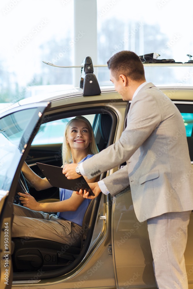 Sticker happy woman with car dealer in auto show or salon