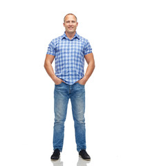 smiling man in checkered shirt and jeans
