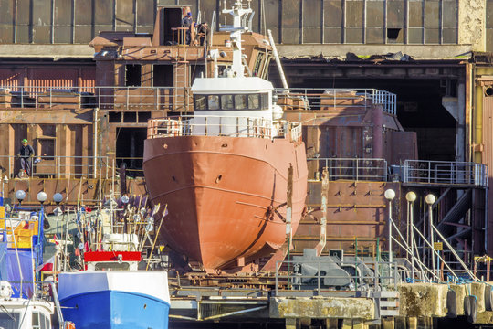 A fishing vessel under maintenance in the dry dock