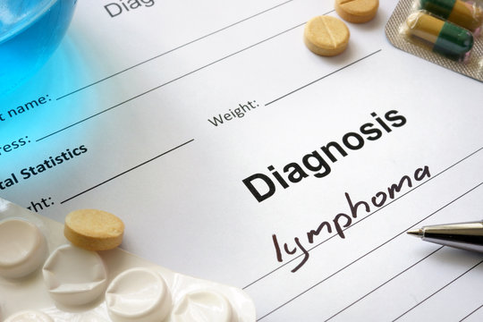 Diagnosis lymphoma written in the diagnostic form and pills.