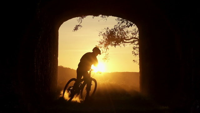 SLOW MOTION: MTB rider stopping at sunset