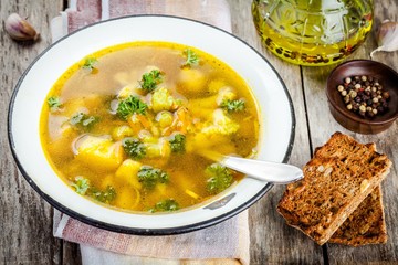 homemade vegetable soup with broccoli, cauliflower, carrots in a bowl