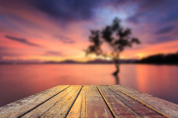 Fototapeta na wymiar Top of old wooden table with blur sunset background