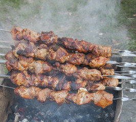 Skewers with meat on the barbecue grill