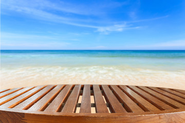 Empty top of wooden table and view of tropical beach