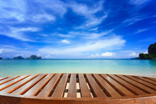 Empty top of wooden table and view of tropical beach