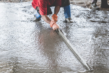 Mason building a screed coat cement