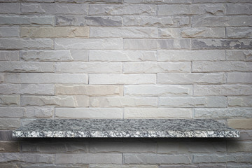 Empty top of natural stone shelves and stone wall background