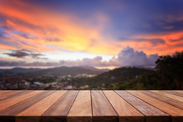 Empty top of wooden table and view of sunset or sunrise backgrou
