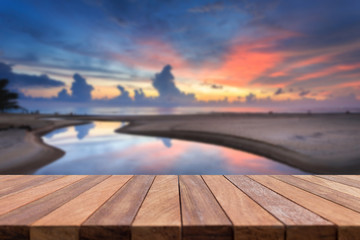 Empty top of wooden table and view of sunset or sunrise backgrou
