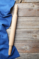 Empty wooden table with rolling pin and napkin on grey backgroun
