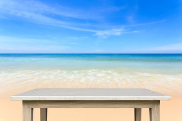 Empty top of natural stone table and view of tropical beach back