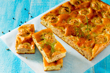 Homemade pie with fish balls on a wooden table