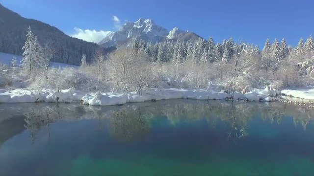 AERIAL: Beautiful mountain lake in winter landscape