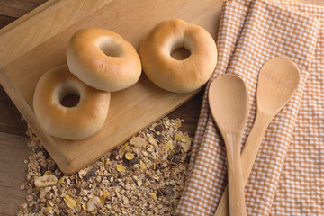 bagle and wheat grain on cutting board top view.jpg