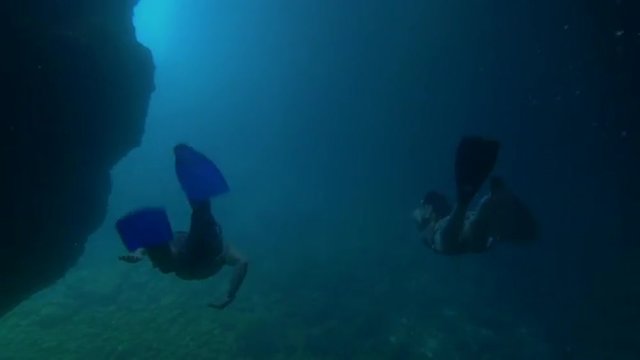 UNDERWATER: Divers swimming out od the cave