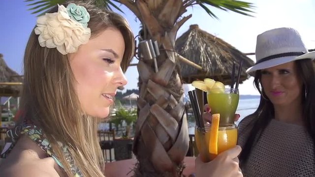 SLOW MOTION: Young women toasting with cocktails
