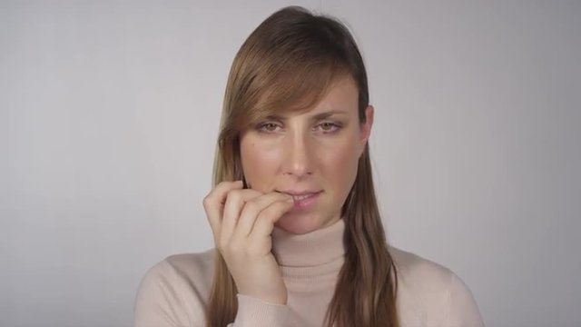 Nervous woman biting her fingernails