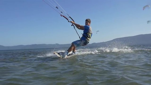SLOW MOTION: Advanced kiteboarder extreme jumping trick