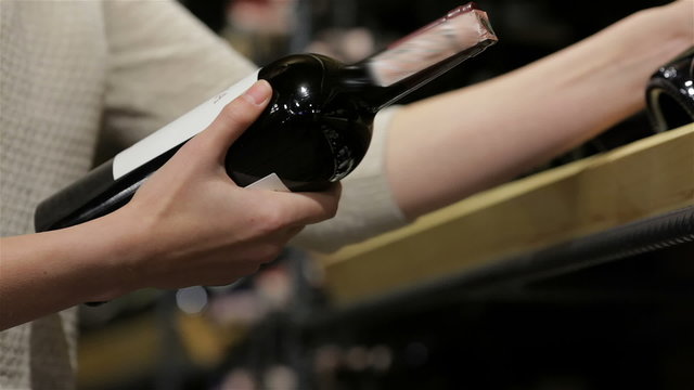 Close up womans hands comparing two wines