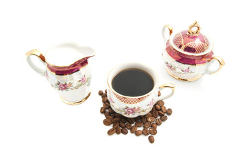 cup of coffee, sugar bowl and coffee beans