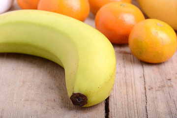 Fresh colorful fruits composition mandarin, bananas and orange