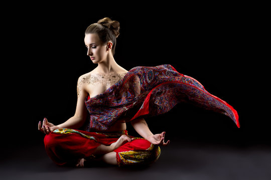 Beautiful calm woman meditates in lotus position